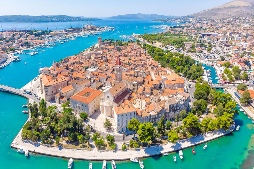 Birds eye perspective on historic Trogir, Croatia,  in summer with turquoise bay waters and mountains