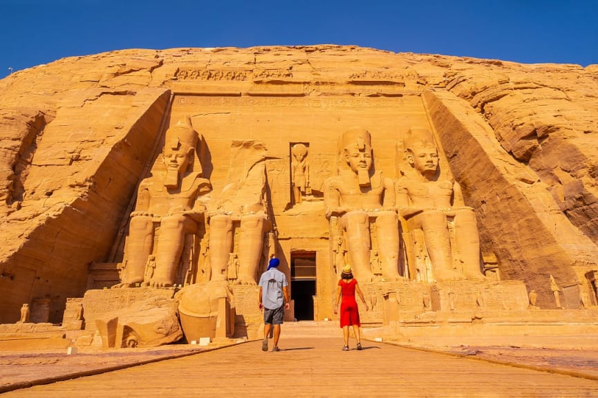 Couple standing outside of Abu Simbel Temple in Aswan, Egypt