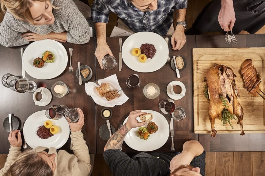 Overhead view of group of people preparing to eat at Posthotel, a Michelin star restaurant in Germany