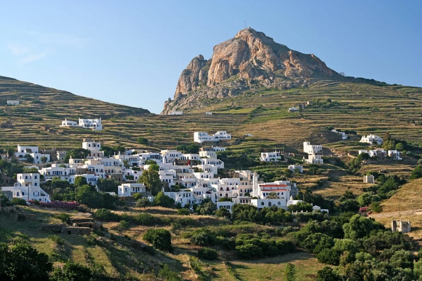 Greek island village with white houses on a the hillside of Exobourgo Mountain on Tinos Island, Greece