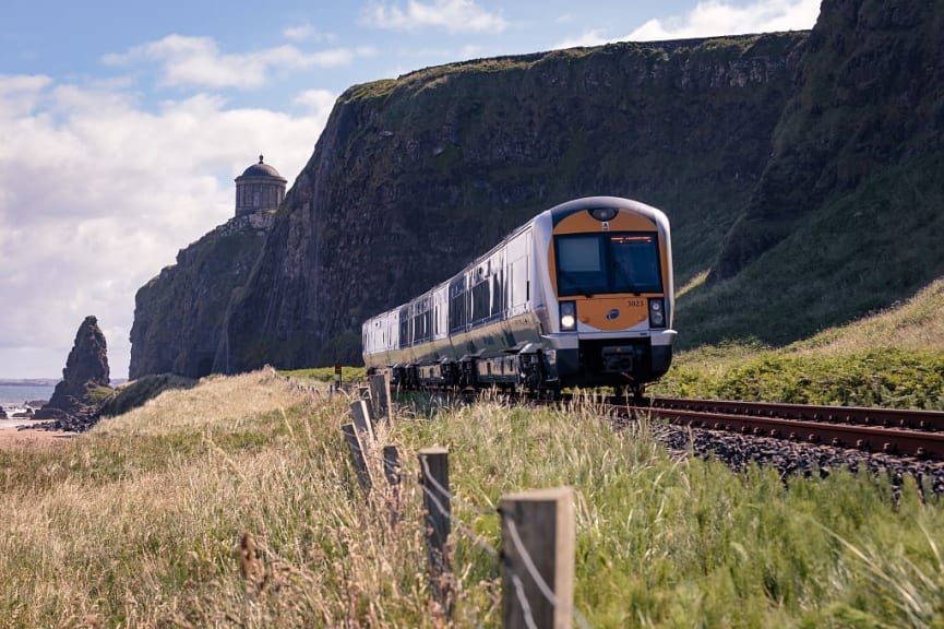 Train in County Londonderry with Mussenden Temple in the background.  Photo courtesy of Matthew Woodhouse / Tourism Ireland