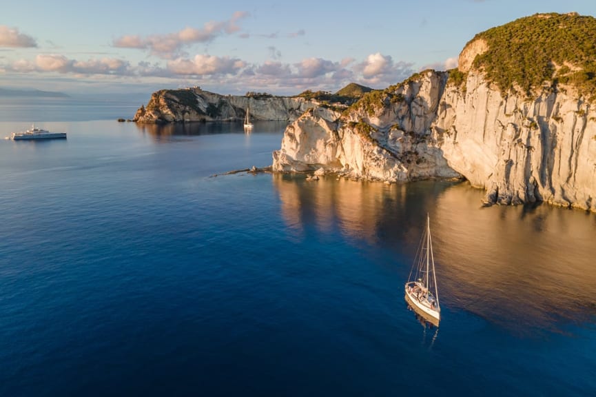 Sailboats at sunset around the beautiful island of Ponza in Italy