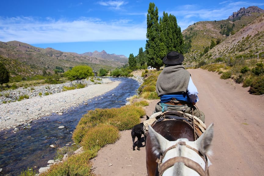 Horseback riding along river in Argentinian Patagonia