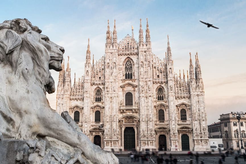 Lion statue and the cathedral in Milan, Italy