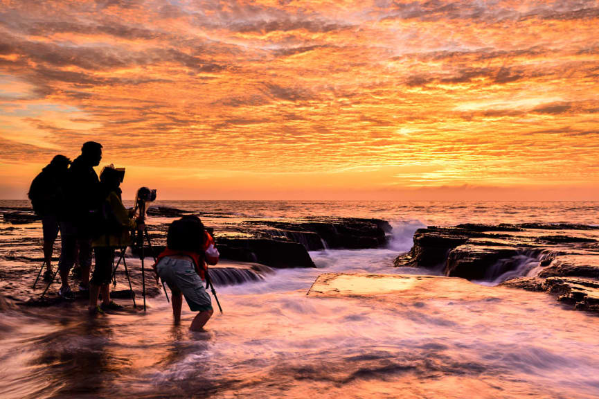 Photographers capturing sunrise on the North Narrabeen coast near Sydney, Australia