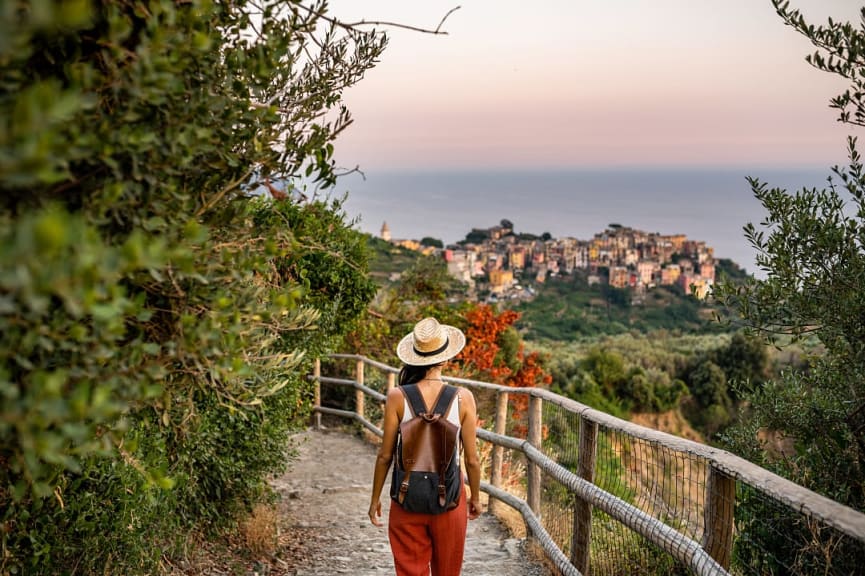 Female traveler walking the trail towards Corniglia in the Cinque Terre, Italy