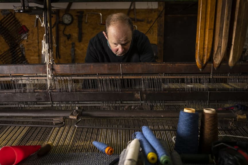 Artisan working on a tartan at Islay Woollen Mill in Scotland