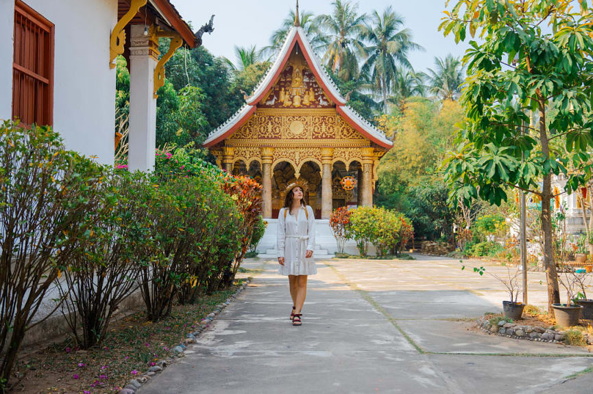 Female tourist exploring temples in Luang Prabang, Laos 