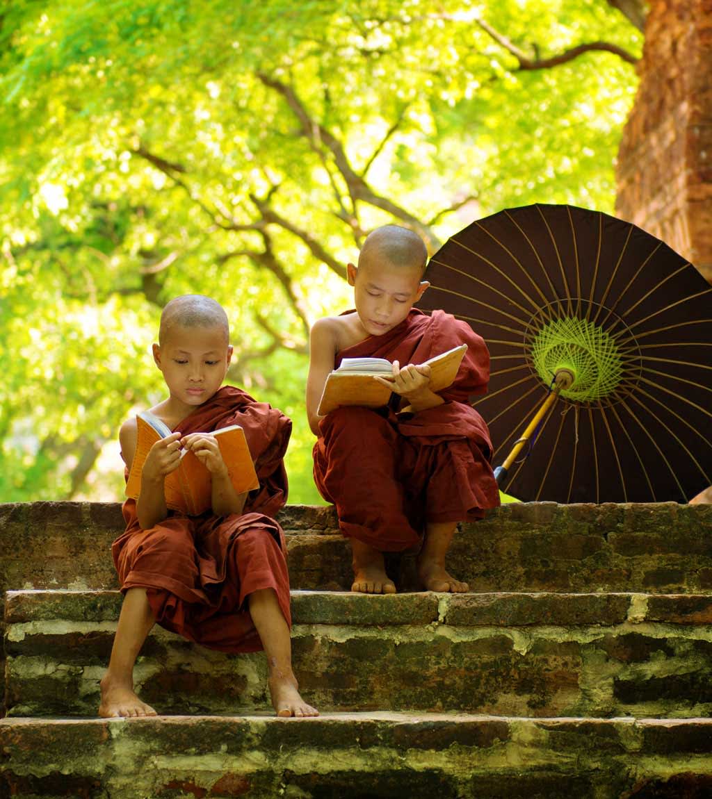 Luxury Tours - Young Buddhist monks reading on landing