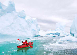 Kayaking around icebergs in Antarctica