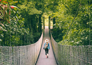 Tourist hiking across hanging bridge in Monteverde, Costa Rica