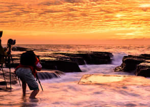 Photographers capturing sunrise on the North Narrabeen coast near Sydney, Australia