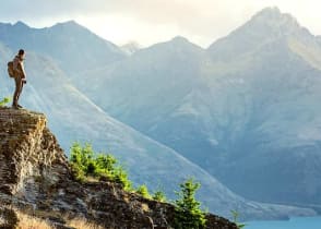 Hiker looking over lake in Queenstown, New Zealand