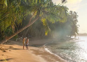 Couple at paradise beach of Manzanillo Park in Costa Rica