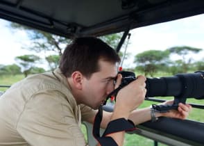 Photographer taking pictures on game drive in Tarangire National Park, Tanzania