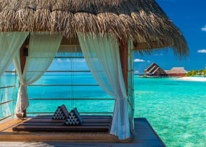 Bungalows over turquoise water in Bora Bora