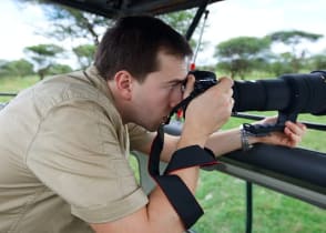 Photographer on game drive in the African savannah