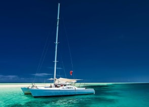 White catamaran on tropical island in Fiji