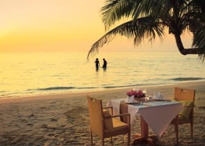 Honeymoon couple enjoying a romantic dinner on the beach in Costa Rica