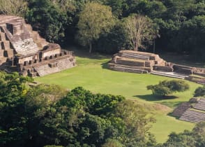 Mayan temples rise above the treetops like ancient skyscrapers.