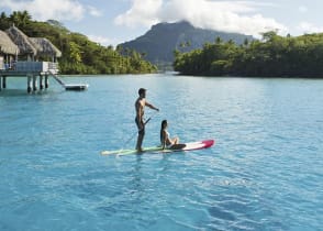 Couple stand up paddleboarding in Bora Bora, Tahiti 