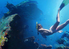 Woman exploring USAT Liberty wreckage off the coast of Bali