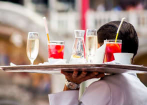 Waiter serving aperitif drinks in Venice, Italy