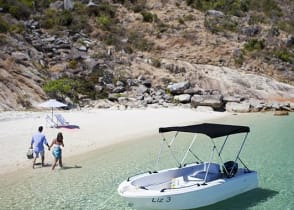 Couple on secluded beach on Lizard Island, Australia