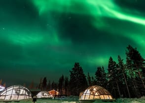 Aurora Borealis above igloos in Finland