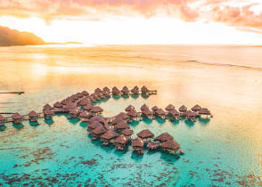 Overwater bungalows along coral reef in Moorea, French Polynesia