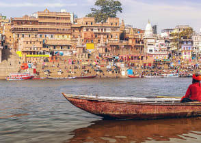 Sadhu on a wooden boat on river Ganges, India