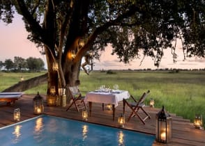 Guest private dining on the pool deck at Duba Plains Camp in the Okavango Delta, Botswana