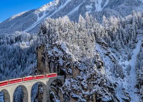 Glacier Express train traveling through the alps in Switzerland