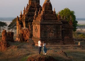 Couple enjoying view of a buddhist temple in Myanmar