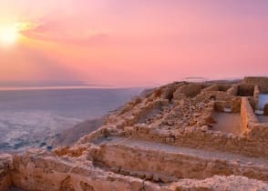 Sunset over Masada fortress in Judaea desert, Israel