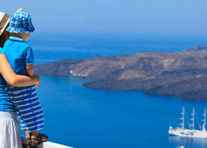 Mother and son looking out over the water in Santorini, Greece