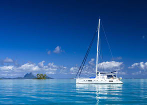 Catamaran sailing the crystal clear blue waters in Tahiti