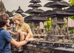 Dad and son tourists in traditional Balinese hindu temple