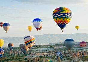 Colorful balloons fly over the Cappadocia valley in Turkey