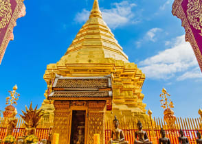 Golden temple framed by ornate archway at Wat Phra That Doi Duthep in Chiang Mai, Thailand