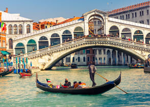 Gondola ride near the Rialto Bridge on the Grand Canal in Venice, Italy