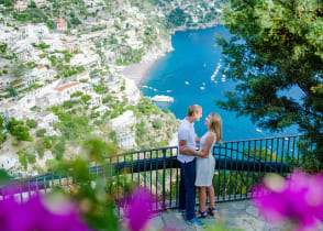 Couple enjoying a moment on the Amalfi Coast with a view of Positano in Italy