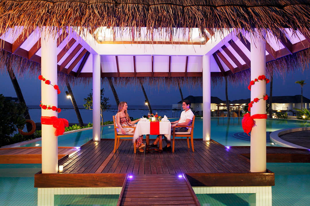 Couple enjoying a luxury dinner at Machchafushi, photo courtesy of Centara Hotels & Resorts.
