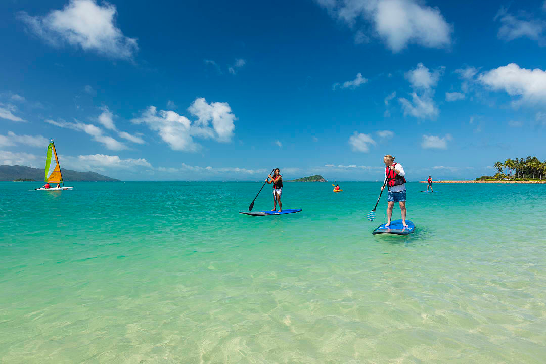 People paddle boarding in Whitsundays, Australia. Photo provided by Tourism Australia.