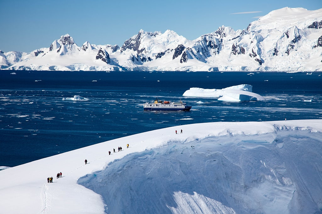 People exploring snowpacked Antarctica