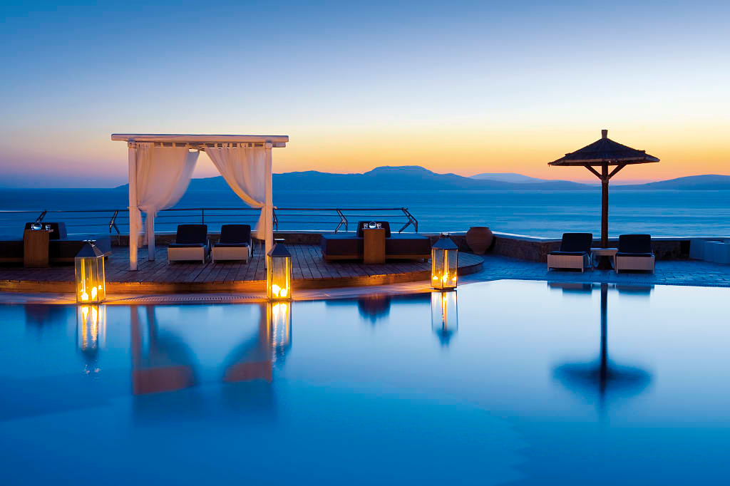 Mykonos Grand Resort pool area at sunset in Greece. Photo courtesy Mykonos Grand Hotel and Resort