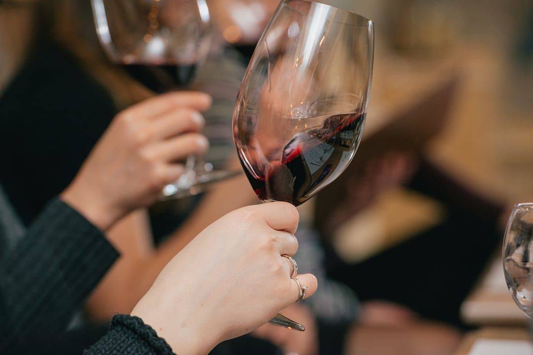 Close up of hands swirling wine during a wine tasting
