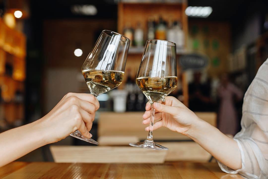 Friends cheering with white wine.
