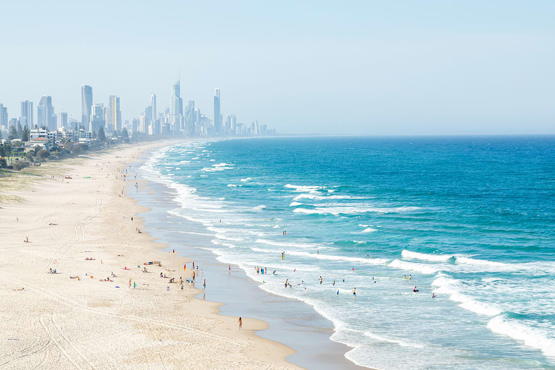 People swimming and surfing in the Gold Coast, Australia.