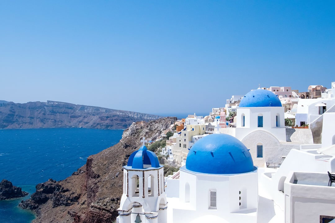 White-washed buildings with blue domes in Santorini, Greece